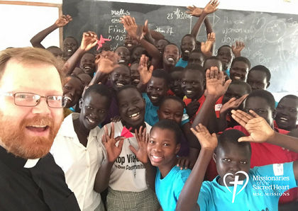 Fr Alan Neville with students in Rumbek